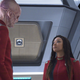 Saru and Michael Burnham talk to each other in one of Discovery's corridors.
